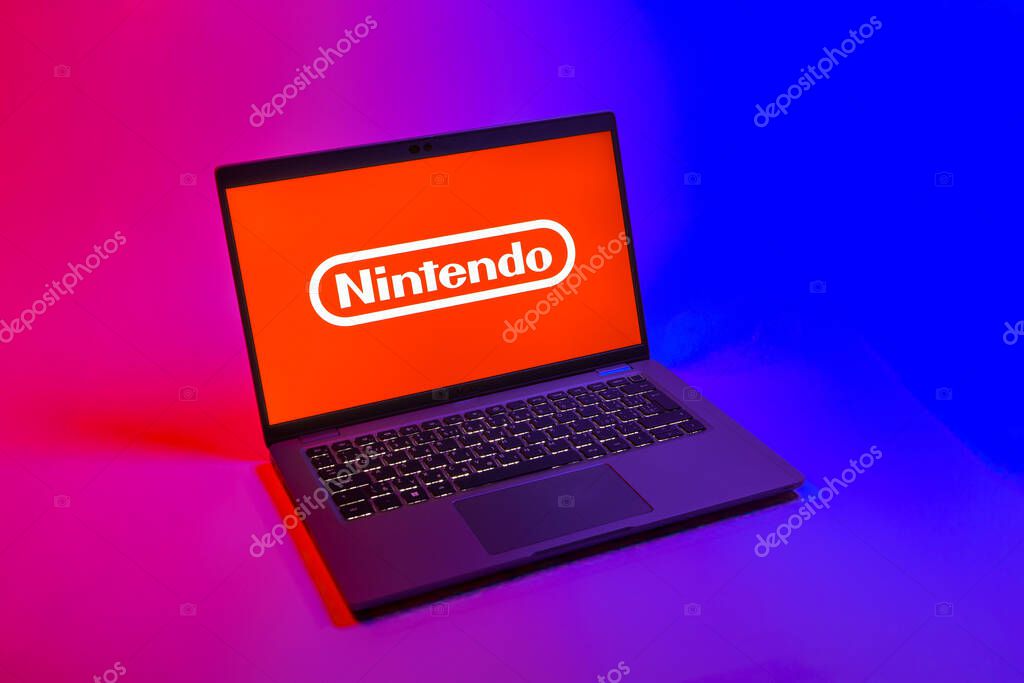 Prague, Czechia - 08 12 2025: A top-down view of a laptop on a uniform background displaying the Nintendo logo. Nintendo is a company producing video game consoles and games.