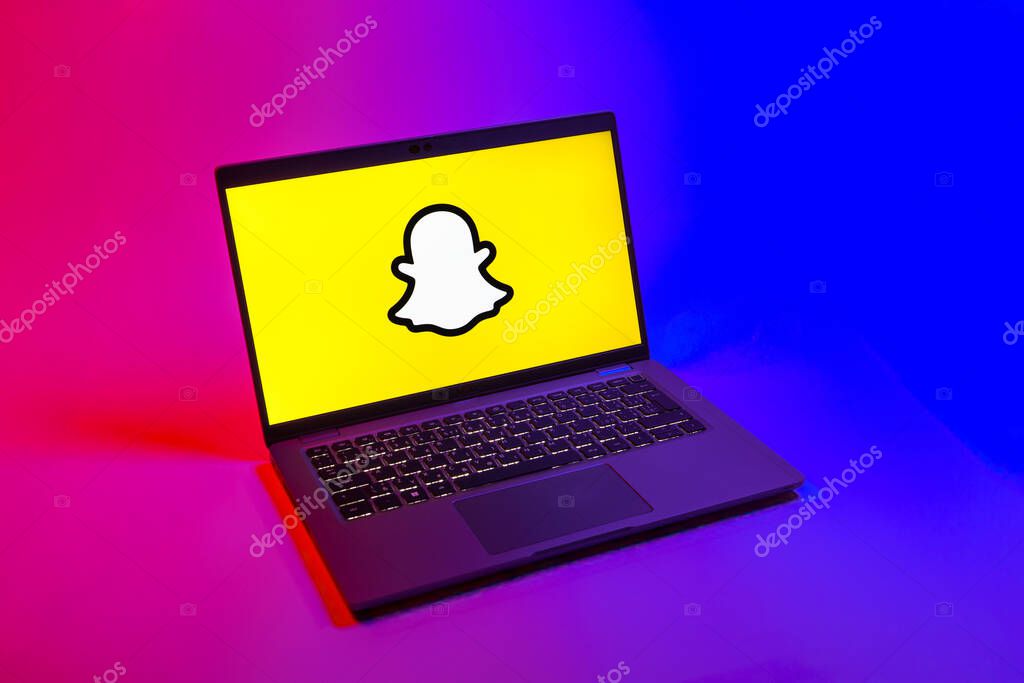Prague, Czechia - 08 12 2025: A top-down view of a laptop on a uniform background displaying the Snapchat logo. Snapchat is an app for sending photos, videos, and temporary messages.