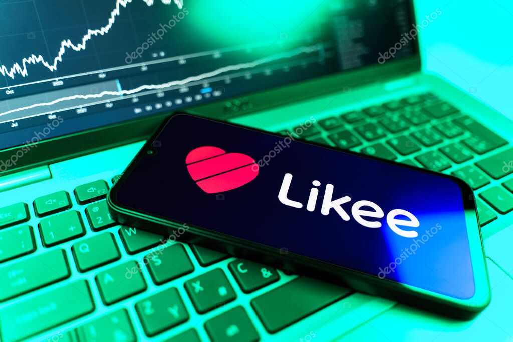 Prague, Czechia - 09 02 2025: Phone on laptop with stock chart showing Likee logo. Likee is a platform for creating and sharing short videos.