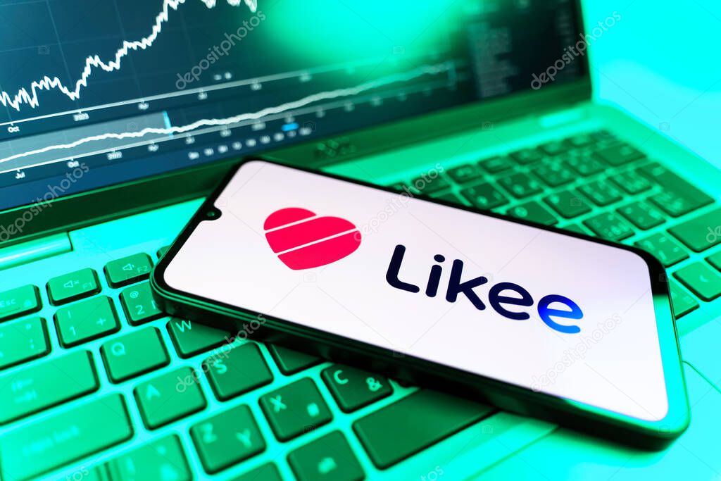 Prague, Czechia - 09 02 2025: Phone on laptop with stock chart showing Likee logo. Likee is a platform for creating and sharing short videos.
