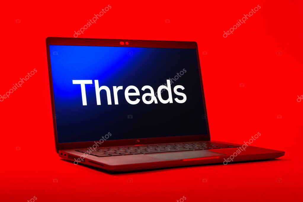 Prague, Czechia - 05 18 2025: A low-angle view of a laptop displaying Threads logo. Threads is a social media platform for sharing short posts and updates.