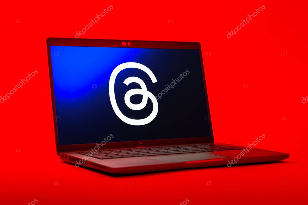 Prague, Czechia - 05 18 2025: A low-angle view of a laptop displaying Threads logo. Threads is a social media platform for sharing short posts and updates.