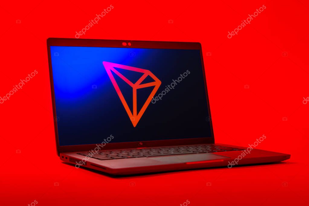 Prague, Czechia - 05 18 2025: A low-angle view of a laptop displaying Tron logo. Tron is a blockchain platform for decentralized applications.