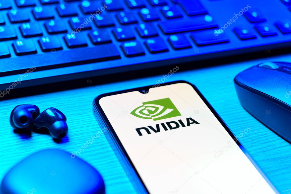 Prague, Czechia - 08 12 2025: A side view of a desk with a keyboard and a mobile phone displaying the NVIDIA logo. NVIDIA is a technology company specializing in GPUs and AI hardware.
