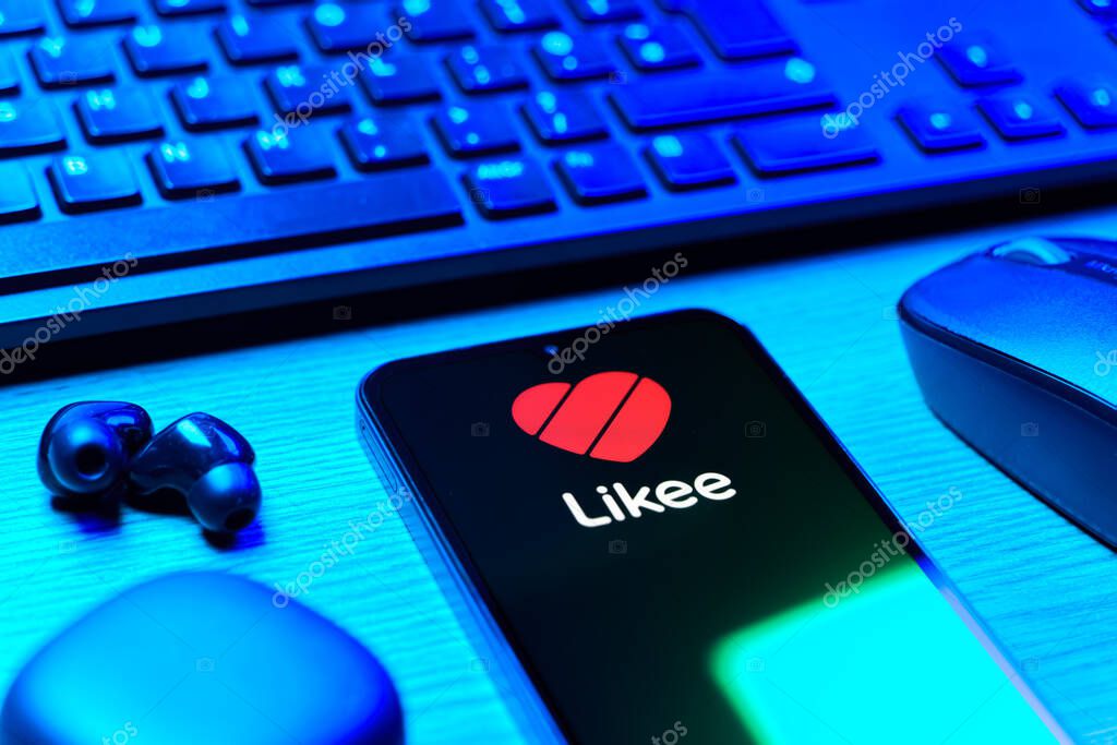 Prague, Czechia - 08 12 2025: A side view of a desk with a keyboard and a mobile phone displaying the Likee logo. Likee is a platform for creating and sharing short videos.