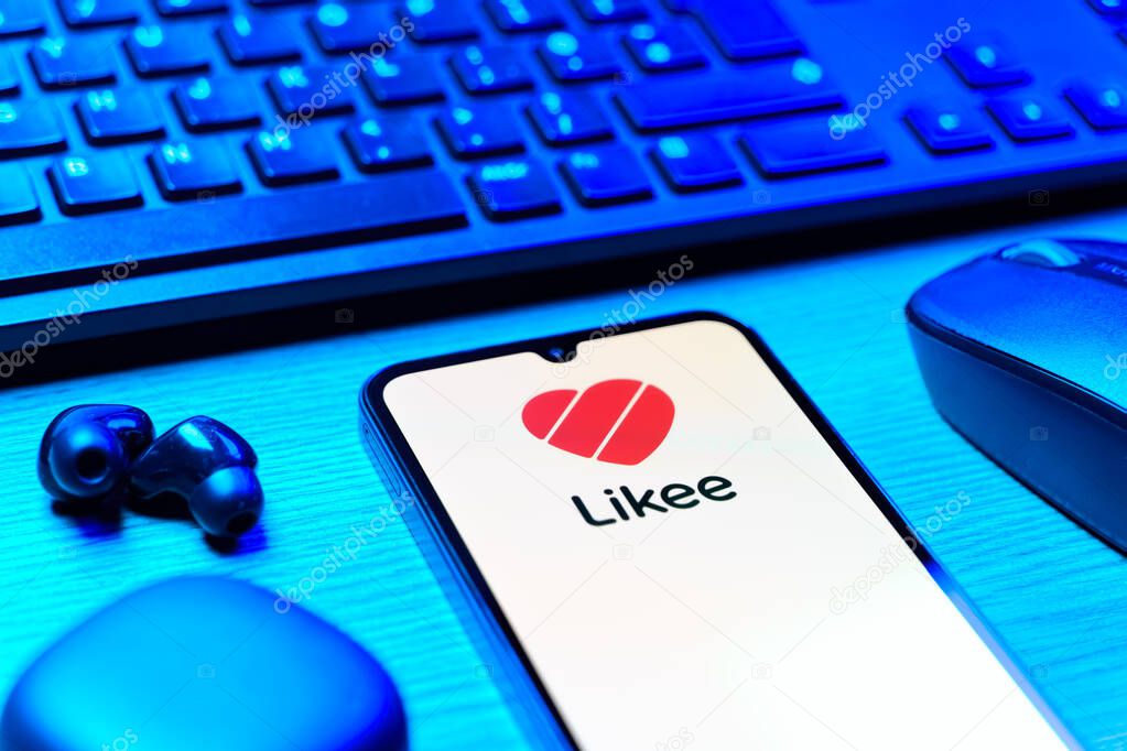Prague, Czechia - 08 12 2025: A side view of a desk with a keyboard and a mobile phone displaying the Likee logo. Likee is a platform for creating and sharing short videos.
