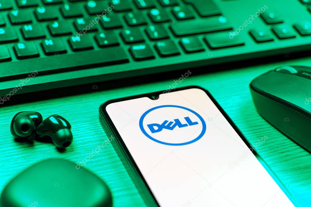 Prague, Czechia - 08 12 2025: A side view of a desk with a keyboard and a mobile phone displaying the Dell logo. Dell is a technology company producing computers and IT solutions.