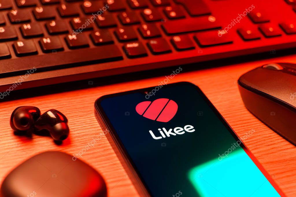 Prague, Czechia - 08 12 2025: A side view of a desk with a keyboard and a mobile phone displaying the Likee logo. Likee is a platform for creating and sharing short videos.