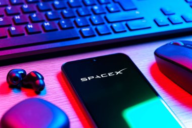 Prag, Çek Cumhuriyeti - 08 12 2025: SpaceX logosunu gösteren klavyesi ve cep telefonu olan bir masanın yan görüntüsü. SpaceX uzay keşfi ve roket fırlatmaları için özel bir şirkettir..