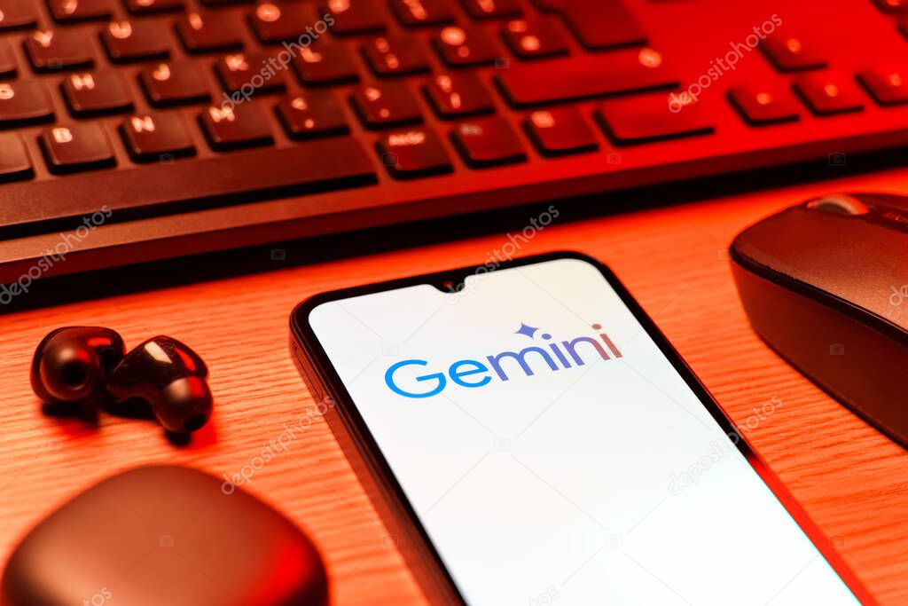 Prague, Czechia - 08 12 2025: A side view of a desk with a keyboard and a mobile phone displaying the Gemini logo. Gemini is a platform for cryptocurrency trading and management.