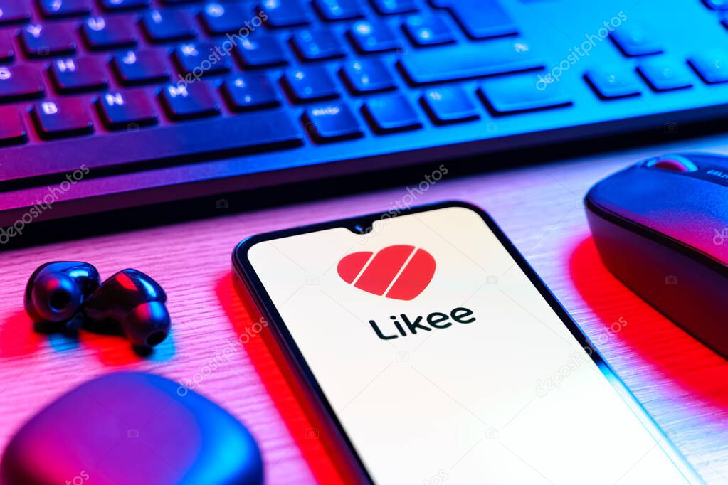 Prague, Czechia - 08 12 2025: A side view of a desk with a keyboard and a mobile phone displaying the Likee logo. Likee is a platform for creating and sharing short videos.