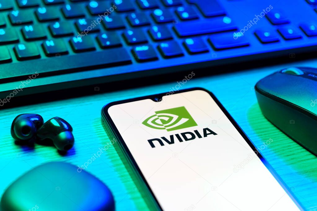 Prague, Czechia - 08 12 2025: A side view of a desk with a keyboard and a mobile phone displaying the NVIDIA logo. NVIDIA is a technology company specializing in GPUs and AI hardware.