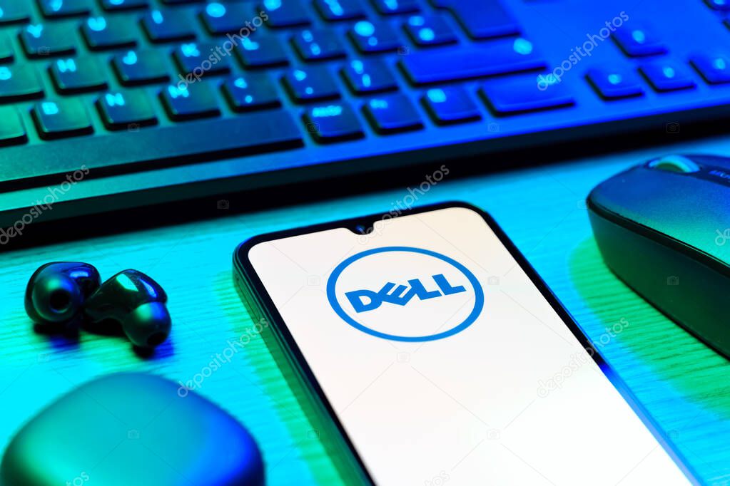 Prague, Czechia - 08 12 2025: A side view of a desk with a keyboard and a mobile phone displaying the Dell logo. Dell is a technology company producing computers and IT solutions.