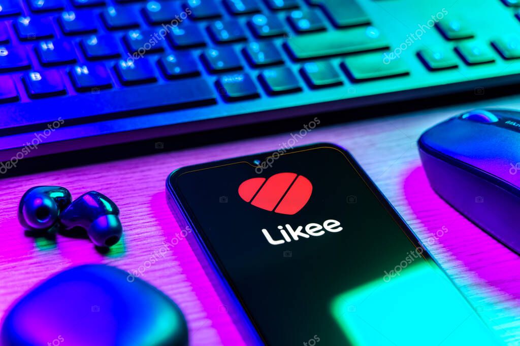 Prague, Czechia - 08 12 2025: A side view of a desk with a keyboard and a mobile phone displaying the Likee logo. Likee is a platform for creating and sharing short videos.