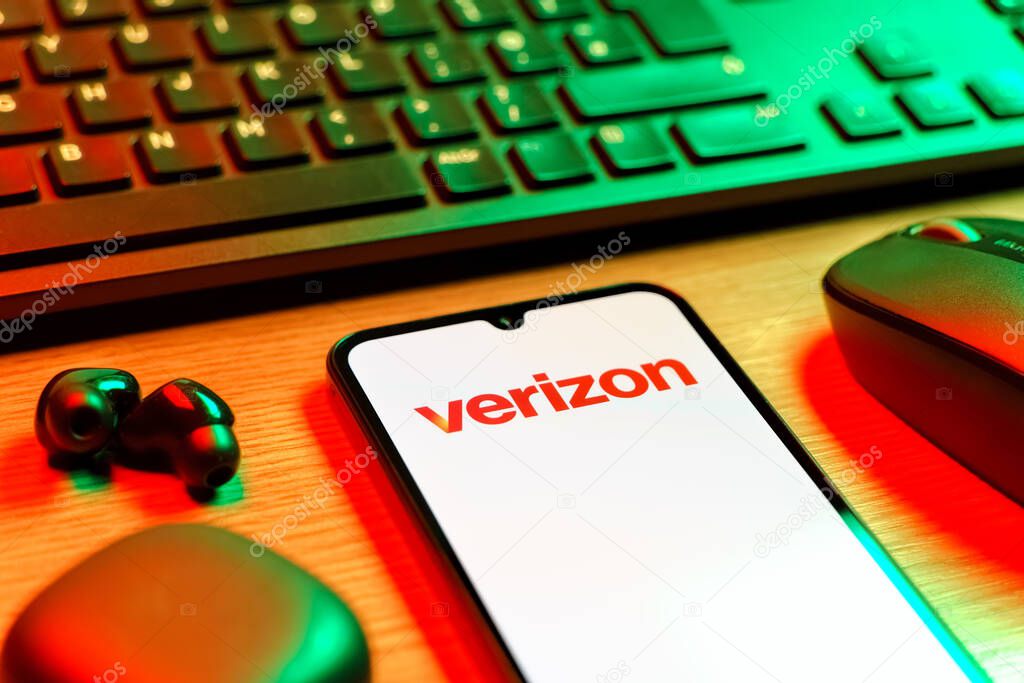 Prague, Czechia - 08 12 2025: A side view of a desk with a keyboard and a mobile phone displaying the Verizon logo. Verizon is a telecom company providing wireless and broadband services.