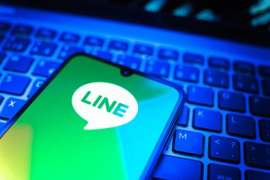 Prag, Çek Cumhuriyeti - 08 19 2025: Bir cep telefonunun klavyede duran ve hat logosunu gösteren yakın plan görüntüsü. Line aramalar, mesajlar ve çokluortam paylaşımı için bir mesajlaşma uygulamasıdır.