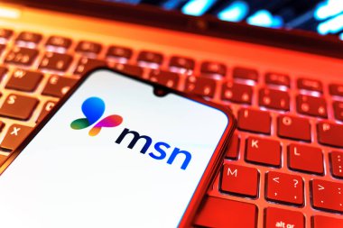 Prag, Çek Cumhuriyeti - 08 19 2025: MSN logosunu gösteren klavyenin üzerinde duran cep telefonunun yakından görüntüsü. MSN haber, e-posta ve çevrimiçi hizmetler için bir platformdur.