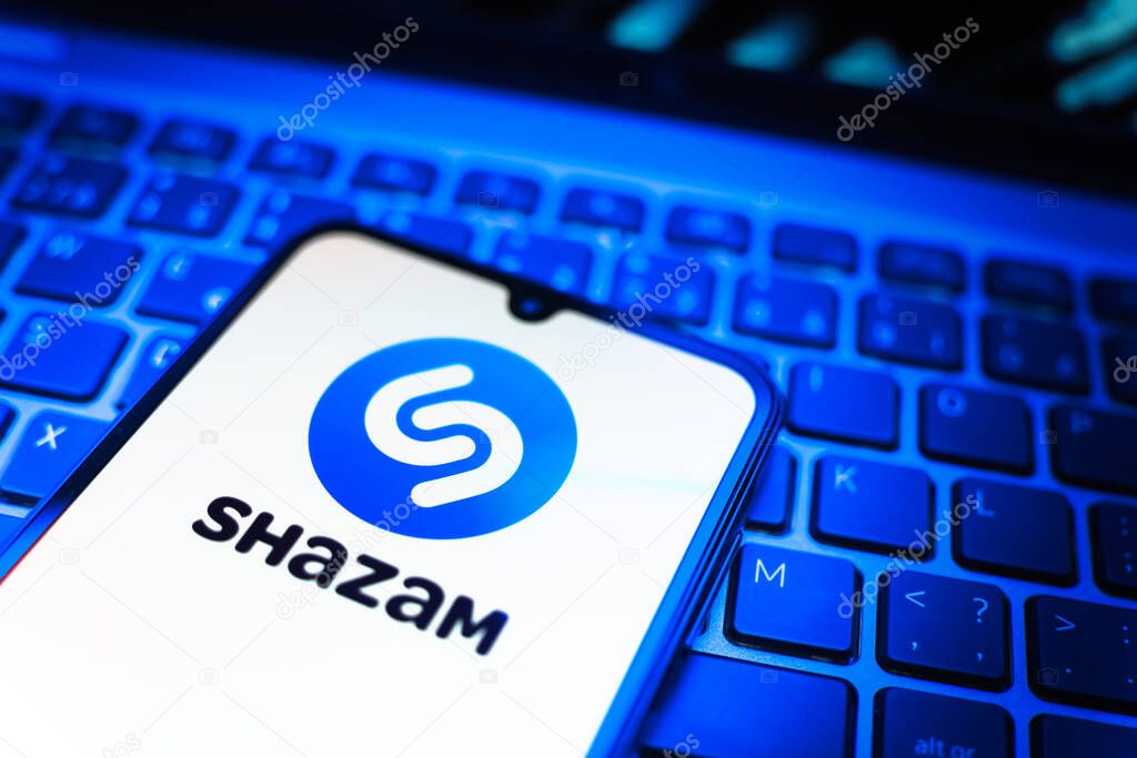 Prague, Czechia - 08 19 2025: A close-up view of a mobile phone lying on a keyboard, displaying Shazam logo. Shazam is an app for identifying songs and music tracks.