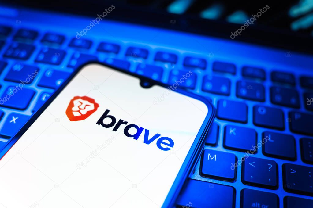 Prague, Czechia - 08 19 2025: A close-up view of a mobile phone lying on a keyboard, displaying Brave logo. Brave is a web browser focused on privacy and speed.