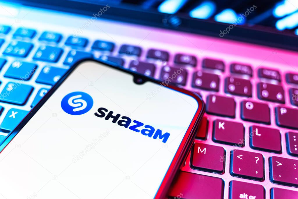 Prague, Czechia - 08 19 2025: A close-up view of a mobile phone lying on a keyboard, displaying Shazam logo. Shazam is an app for identifying songs and music tracks.