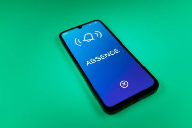 Üniformalı bir arka planda yatan cep telefonunun mesajın eksikliğini gösteren bir detayı. Yokluk, işte bulunmama durumudur..