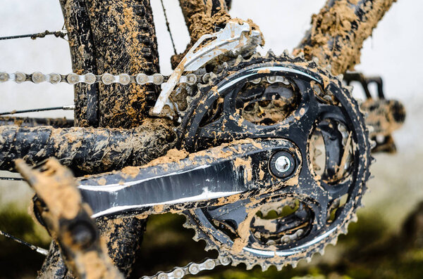 Mountain Bike Transmission in Mud. Dirty Chain Drive of Mountain Bike After Riding in Bad Weather