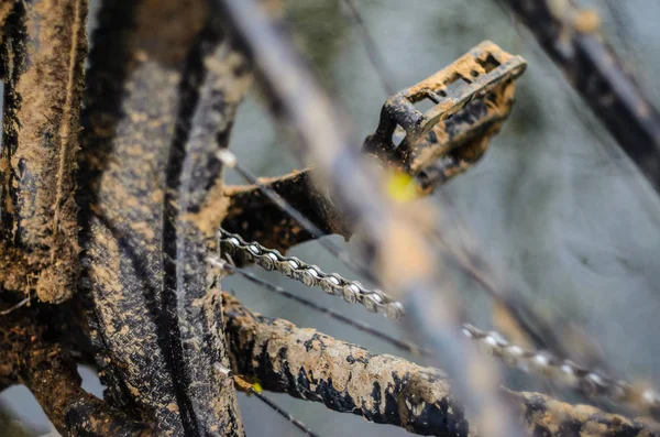 A bicycle in the mud. Elements of a mountain bike frame covered with mud after riding in bad weather