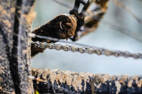 A bicycle in the mud. Elements of a mountain bike frame covered with mud after riding in bad weather