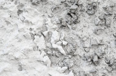 Beton duvar dekorasyon, beyaz boyalı zor. Birçok çıkıntılı taşları ile beyaz beton duvar.