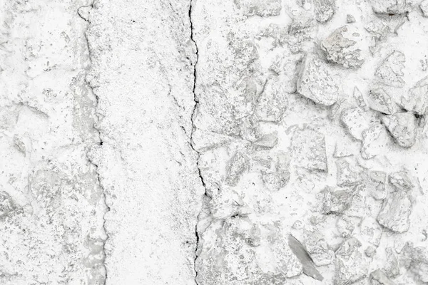 Rough Concrete Wall Decoration, Painted White. White Concrete Wall with Many Protruding Stones.