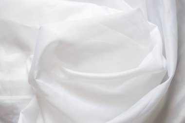 Beyaz sentetik kumaş kıvrımları ile kaplama. Buruşuk sayfa veya elbise arka plan,