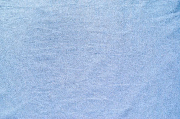 The texture of light blue fabric for shirts. Blank textile background