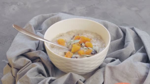 Oatmeal Dried Apricots Prune Pumpkin Seeds Deep Bowl Persimmon Cooking — Stock Video