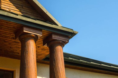 Verandanın tahta sütunları Ev 'e giriş yapıyor.