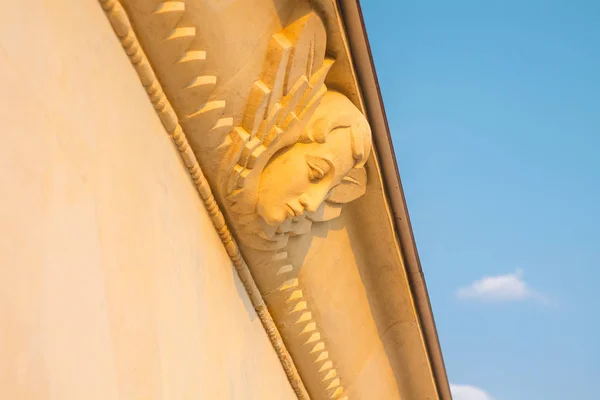 Female Mask Sculpture with Wings on the Building