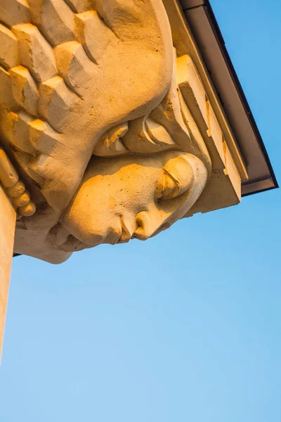 Female Mask Sculpture with Wings on the Building