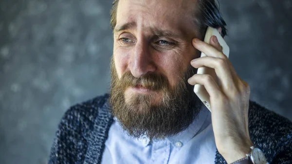 Bearded Man Received Bad News by Telephone