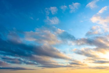 blue sky background with clouds. nature in summer at sunrise. dynamic cloudscape above horizon in morning light. nice image for beautiful outdoor wallpaper