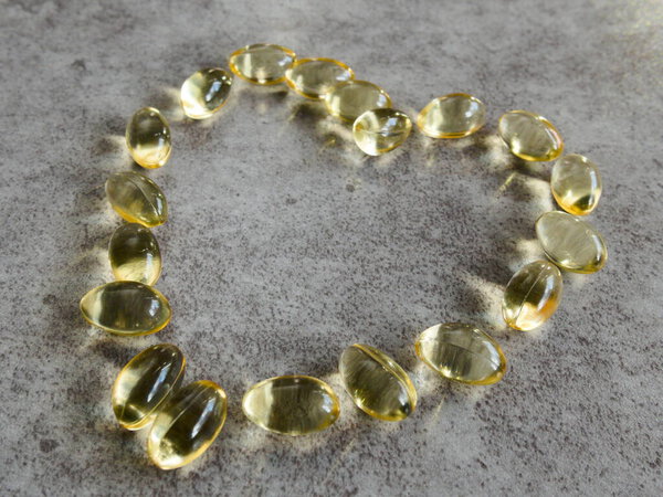 Vitamin D3 capsules arranged in a giant heart