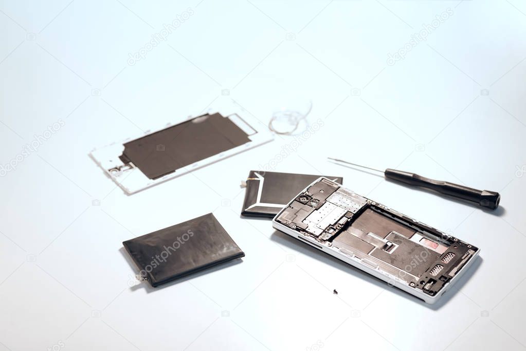 To open smartphone's backside cover to replace a swollen batter. Smartphone repair Concept, (Toned image)