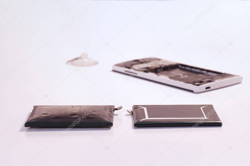Smartphone battery compared swollen battery with a new battery  (Toned image)