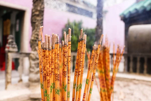Incense sticks burning embossed in Chinese temple.