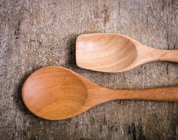 Handcrafted wooden spoons on rustic background.