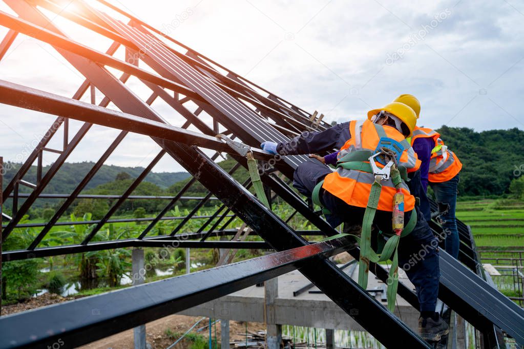 Construction worker wearing safety harness.