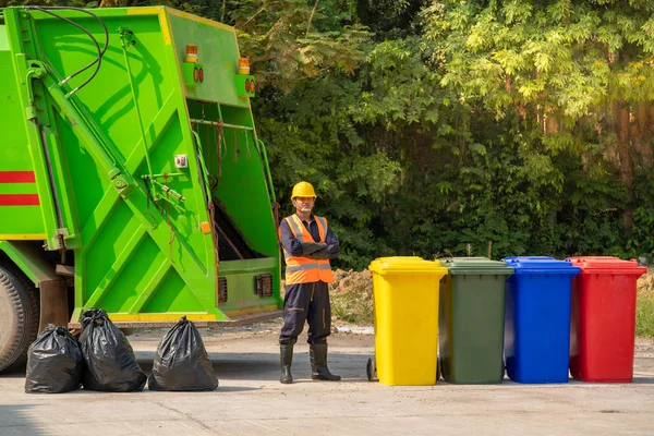 Garbage removal worker in protective clothing working for a publ