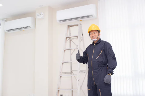 Air Conditioning Technician are servicing air conditioners.