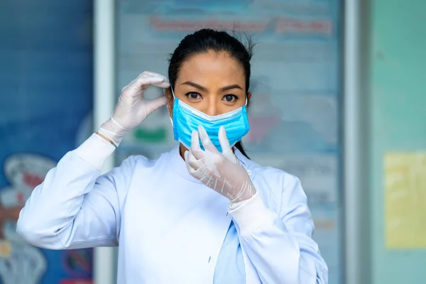 Female doctor wearing protective mask to Protect Against Covid-19,Health care worker in hospital diagnosing patients.