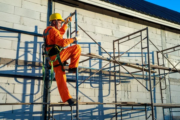 Construction workers wearing safety harness belt during working at high place,Concept of residential building under construction.