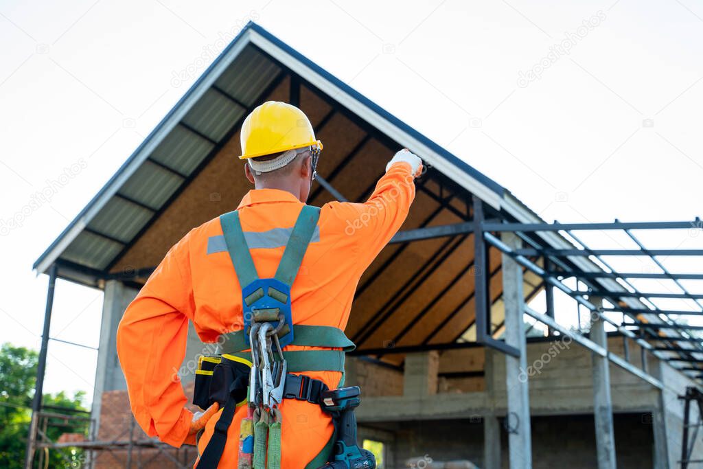 Engineer wearing safety harness and safety line working at high place,Practices of occupational safety and health can use hazard controls and interventions to mitigate workplace hazards.