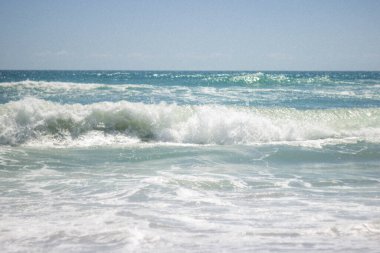 Summer background. Waves in the blue sea on a sunny day. Azure ocean with big waves.